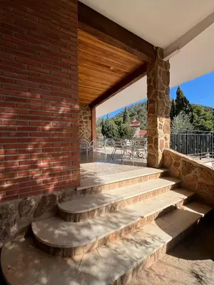 a brick wall with stairs leading to a patio at Cau de Serra 