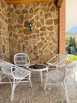 two white chairs and a table on a patio at Cau de Serra 