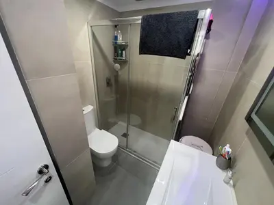a small bathroom with a shower and a toilet at Paradise Cullera in Cullera