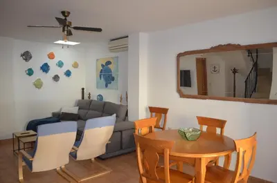 a living room with a table and a couch at Arbocer playa Puçol in Puzol
