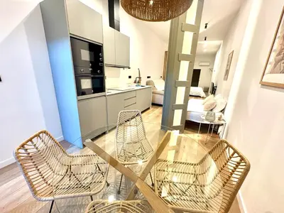 a dining room with a glass table and chairs at Mestalla flats & Rut in Valencia