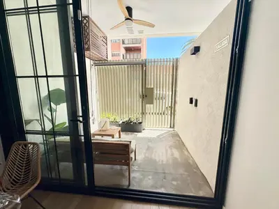 an open glass door to a balcony with a ceiling fan at Mestalla flats & Rut in Valencia