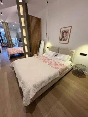 a bedroom with a large bed with a ladder at Mestalla flats & Rut in Valencia