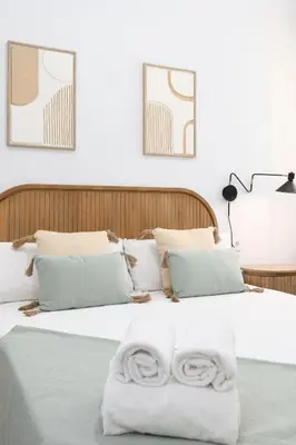 a bedroom with a bed with two towels on it at Travel Habitat Peset Aleixandre Apartments in Valencia