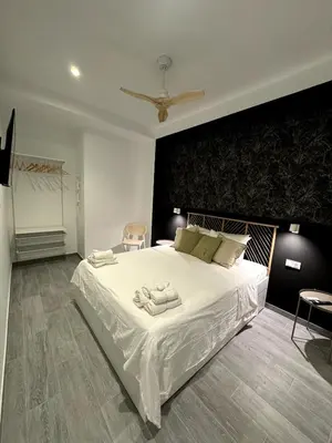 a bedroom with a large white bed with two towels on it at Cozy apartment Valencia in Valencia
