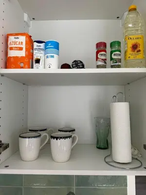 a shelf with two cups and a roll of paper towels at Cozy apartment Valencia in Valencia