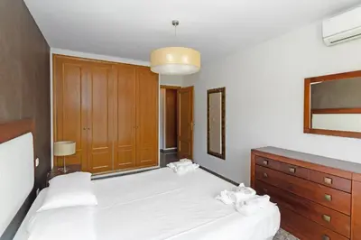 a bedroom with two white beds and a dresser at GuestReady - Delightful Valencia Retreat in Valencia