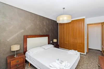 a bedroom with a bed with white towels on it at GuestReady - Delightful Valencia Retreat in Valencia