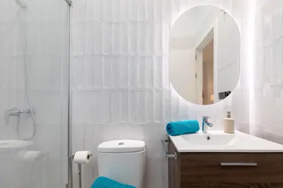 a bathroom with a toilet and a sink and a mirror at Apartamento 2º nuevo 400 mt al mar in Valencia