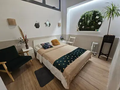 a bedroom with a bed and a chair at Las Artes Luxury Double Room in Valencia