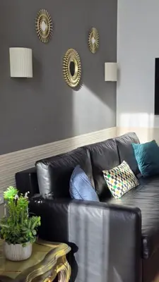 a black leather couch in a living room with a table at Las Artes Luxury Double Room in Valencia