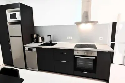 a small kitchen with a stove and a refrigerator at Vacansis Bajo Loft Plus Ultra in Valencia