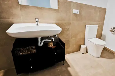 a bathroom with a sink and a toilet at Vacansis Bajo Loft Plus Ultra in Valencia
