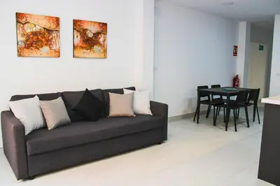 a living room with a couch and a table at Vacansis Bajo Loft Plus Ultra in Valencia