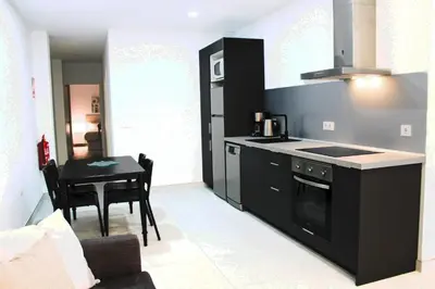 a kitchen with a stove and a table in a room at Vacansis Bajo Loft Plus Ultra in Valencia