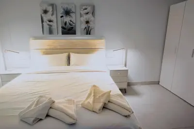 a bedroom with a white bed with two pillows at Vacansis Bajo Loft Plus Ultra in Valencia