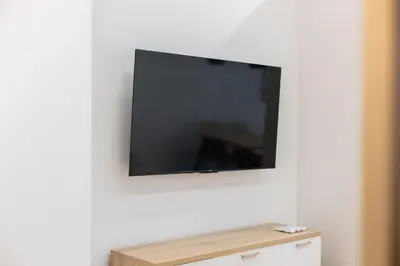 a flat screen tv hanging on a white wall at Luxury Apartment Oceanografic 6 pax in Valencia