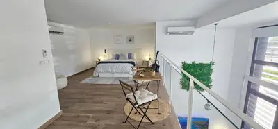 a living room with a large flat screen tv at Dúplex-Lofts Les Arts i Les Ciències in Valencia