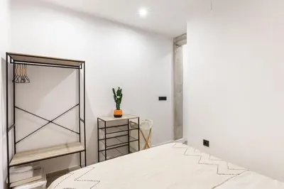 a bedroom with a mirror and a bed at Turía Flats by Nomad Host in Valencia