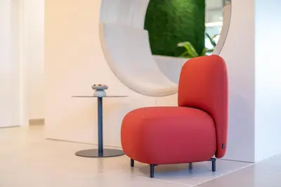 a red chair in a room with a mirror at NIDO Malvarrosa Hotel - Apartamento in Valencia