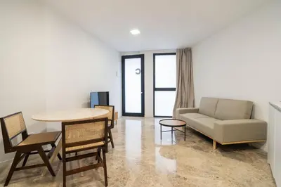 a living room with a couch and a table and chairs at VLC Host - Tamarit in Valencia