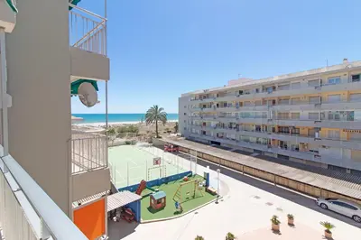 a view from the balcony of a building with a tennis court at Global Vacacional, Apartamento en primera linea de playa en Canet de Berenguer in Canet de Berenguer