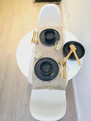 a white table with black plates and glasses on it at Cozy Retreat in Heart of Valencia Perfect for Couples n Families in Valencia