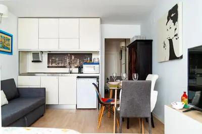a small kitchen and living room with a couch and a table at Cozy Suite next to Plaza del Ayuntamiento in Valencia