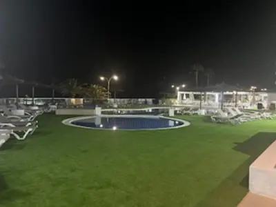a resort with a swimming pool at night at Espacio-1, 2-H in Cullera