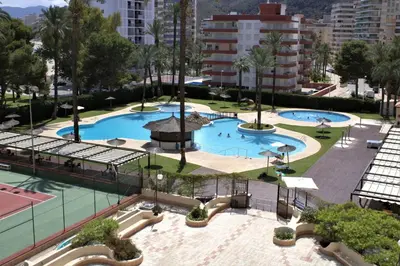 an overhead view of two pools with trees and buildings at Vacansis Apartamento Florazar 2, 4 in Cullera