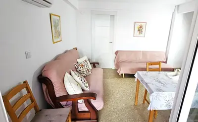 a living room with a couch and a table at Vacansis Apartamento Cullera Mar in Cullera
