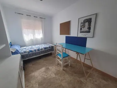 a kitchen with white cabinets and a blue floor at Patriarch's Alfara Room in Alfara del Patriarca