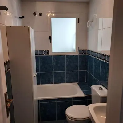 a small bathroom with a toilet and a window at Patriarch's Alfara Room in Alfara del Patriarca