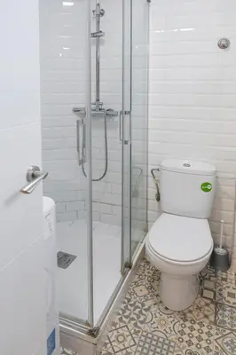 a bathroom with a toilet and a glass shower at Colomer Silence in Valencia