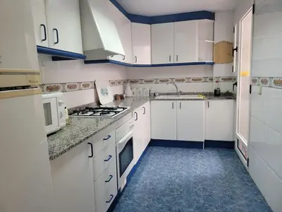 a bedroom with a bed and a table and a desk at Room with private bathroom in Alfara del Patriarca