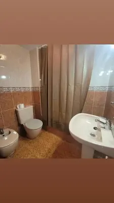 a bathroom with a toilet and a sink at Room with private bathroom in Alfara del Patriarca