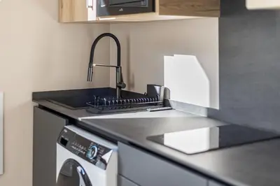 a kitchen with a sink and a counter top at Suite Premium junto al Río Turia 1 in Valencia
