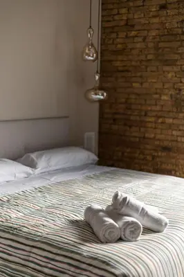 a bed with two towels sitting on top of it at Suite Premium junto al Río Turia 2 in Valencia