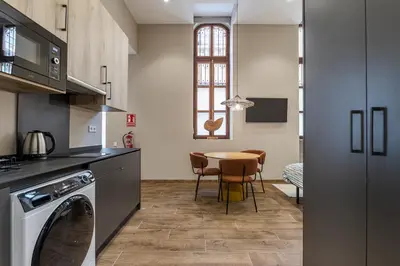 a kitchen with a table and a dining room at Suite Premium junto al Río Turia 2 in Valencia