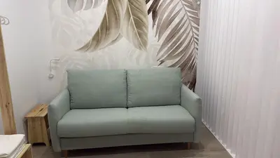 a green chair in a room with a wall at Salabert Suite in Valencia
