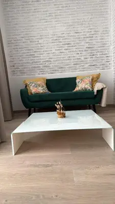 a living room with a green couch and a white coffee table at Salabert Suite in Valencia