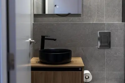 a bathroom with a black sink and a mirror at Premium Suite by the Turia River 3 in Valencia