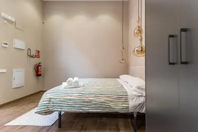 a bedroom with a bed with white towels on it at Premium Suite by the Turia River 4 in Valencia