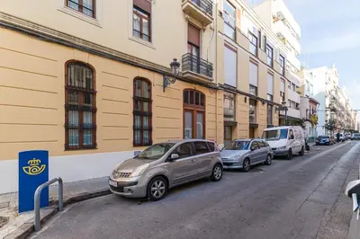 a row of cars parked on the side of a street at Premium Suite by the Turia River 4 in Valencia