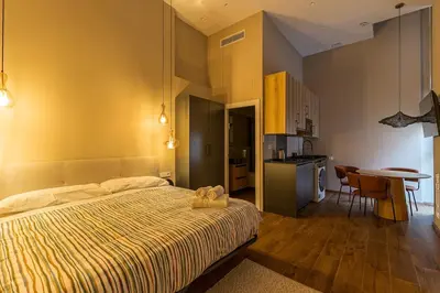 a bedroom with a bed and a kitchen with a table at Premium Suite by the Turia River 4 in Valencia