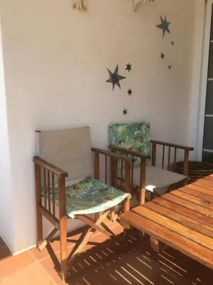 two chairs and a table in a room with stars on the wall at La Calita del Versalles in Faro de Cullera