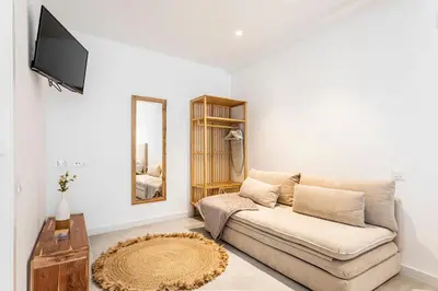 a living room with a couch and a flat screen tv at BiS Suites Ruzafa in Valencia