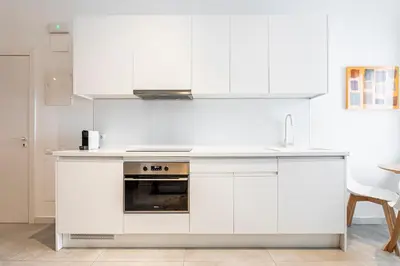 a white kitchen with a sink and a stove at BiS Suites Ruzafa in Valencia