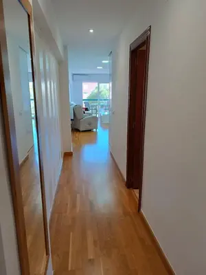 a hallway with a mirror and a living room at Fleming's Beach in Puebla de Farnals