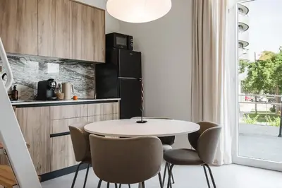a small kitchen with a white table and chairs at Gran Turia Apartments in Valencia